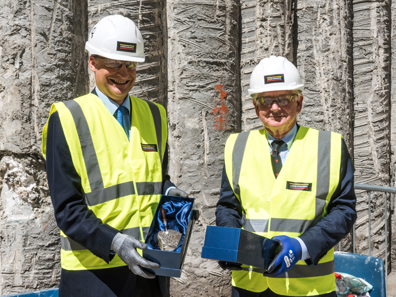Professor John Wheater and Adrian Beecroft holding engraved silver trowels. Photo by the University of Oxford