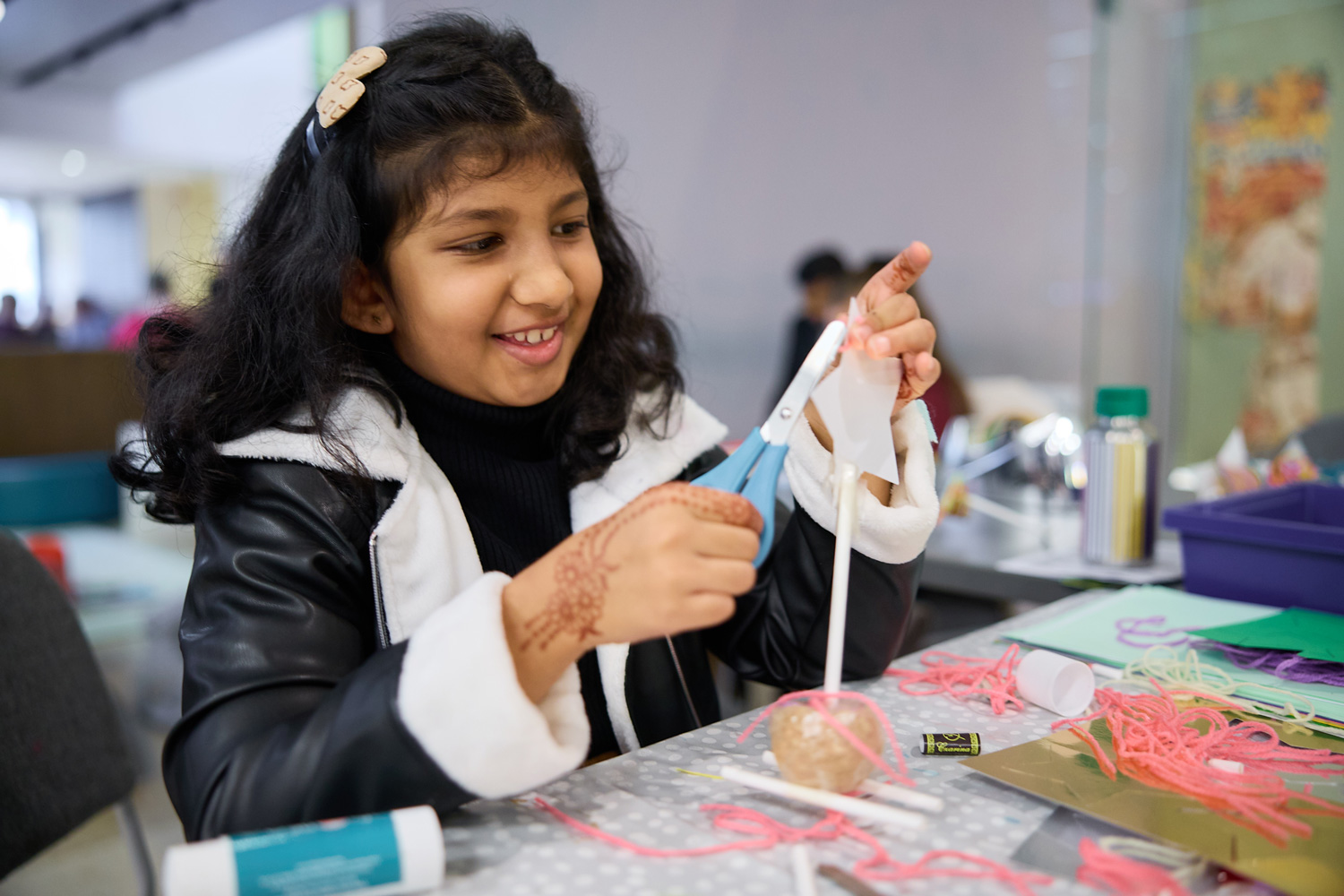 A young girl interacting with exhibit at the Bodleian Libraries